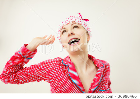 Funny woman wearing pajamas and bathing cap Funny woman wearing pajamas and bathing cap 36980460