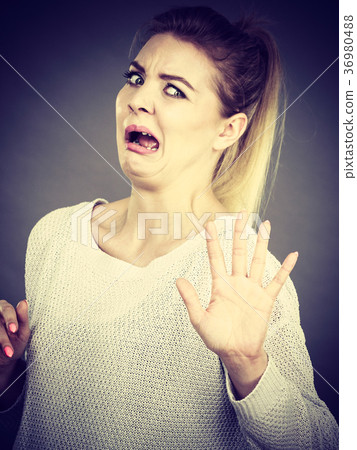 Scared woman gesturing stop gesture with hands Scared woman gesturing stop gesture with hands 36980488