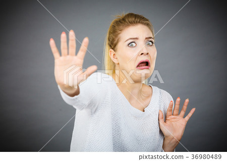 Scared woman gesturing stop gesture with hands Scared woman gesturing stop gesture with hands 36980489