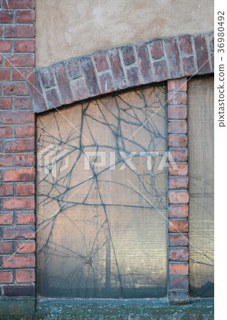 Broken window in old factory building 36980492