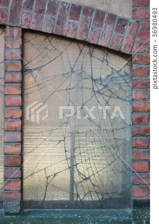 Broken window in old factory building Broken window in old factory building 36980493