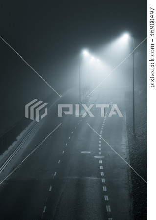 Empty street at foggy night 36980497
