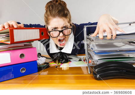 Depressed businesswoman sitting at desk 36980608