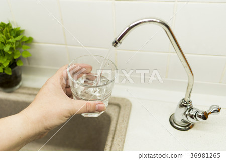 Clear transparent cold water flows from the tap 36981265