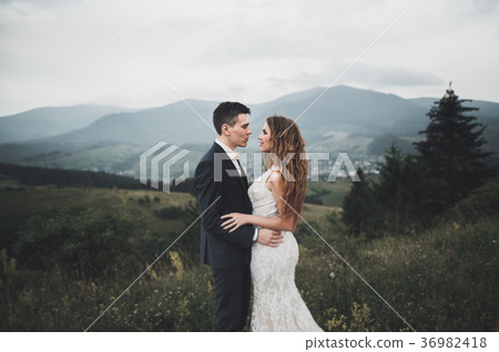 Young newly wed couple, bride and groom kissing Young newly wed couple, bride and groom kissing 36982418