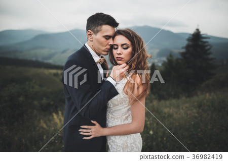 Happy wedding couple posing over beautiful Happy wedding couple posing over beautiful 36982419