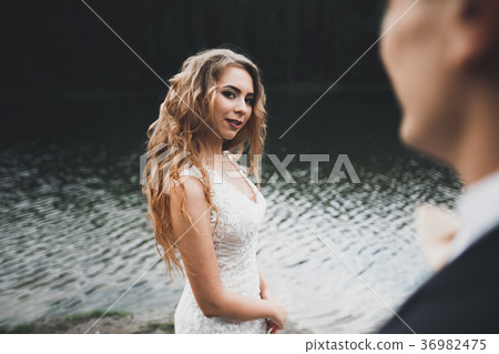 Beautifull wedding couple kissing and embracing Beautifull wedding couple kissing and embracing 36982475