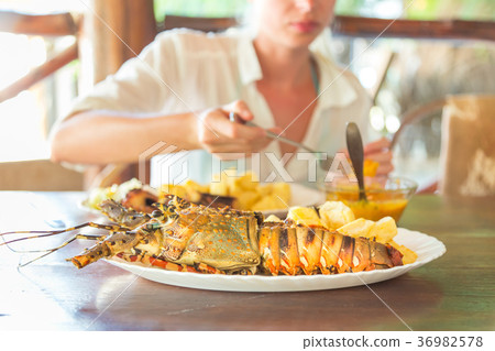Grilled lobster served with potatoes and coconut 36982578
