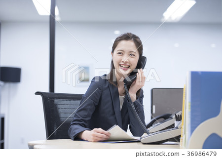 年輕女性僱員講話與在公司電話的微笑 36986479