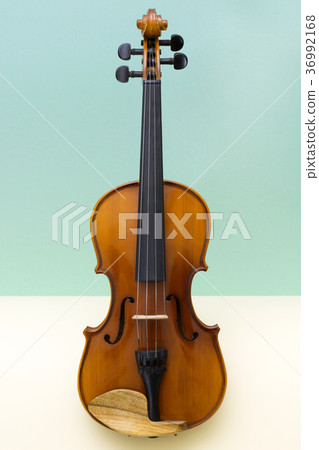 Musical instrument violin on a colored background Musical instrument violin on a colored background 36992168