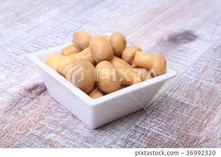 Marinated champignons in white bowl. Marinated champignons in white bowl. 36992320