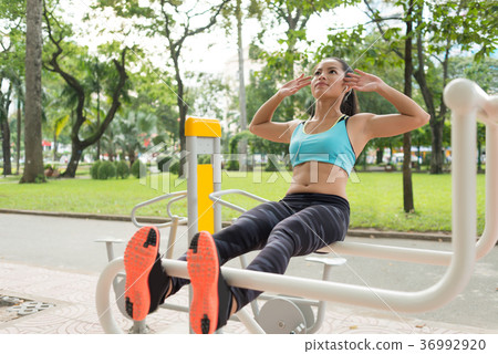 Exercising young woman Exercising young woman 36992920