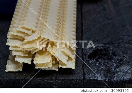 Reginette noodles on dark rustic wood 36993505