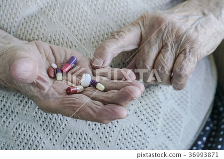 pills on palm of a senior woman pills on palm of a senior woman 36993871