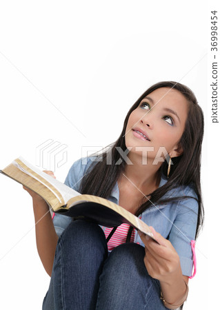 Beautiful young woman holding a Bible 36998454