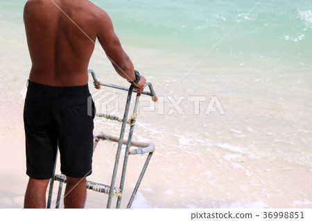 Lifeguards with ladders for the boat on the beach 36998851