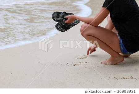 Tourists girl with sandal enjoy the beach and sea 36998951
