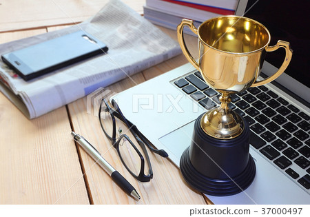 Trophy on working table , winner concept. 37000497