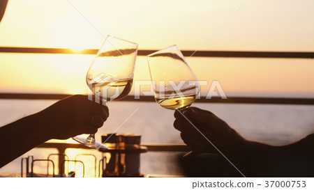 People holding glass of wine, making a toast over 37000753