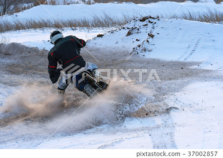 Racer man fulfills a fast ride on a motorcycle Racer man fulfills a fast ride on a motorcycle 37002857