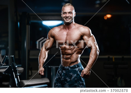Brutal strong bodybuilder athletic men pumping up muscles with d Brutal strong bodybuilder athletic men pumping up muscles with d 37002878