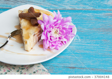 White plate with a piece of cheesecake 37004148