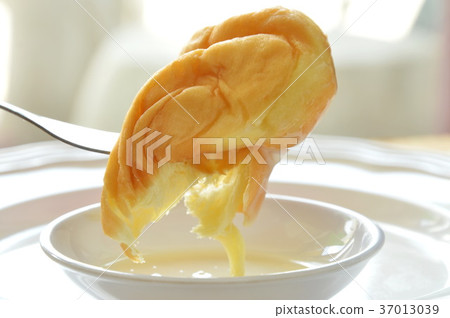 soft twist bread dipping sweetened condensed milk soft twist bread dipping sweetened condensed milk 37013039