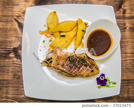 Food on a plate, on a wooden background Food on a plate, on a wooden background 37013473