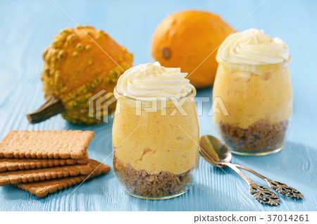 No bake pumpkin cheesecake with whipped cream. 37014261