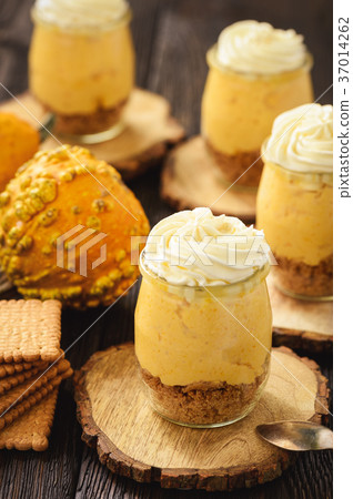 No bake pumpkin cheesecake with whipped cream. 37014262
