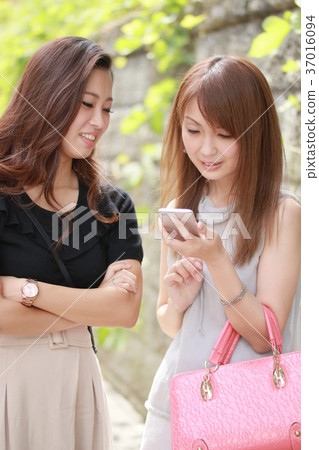 Two young women searching for smartphones 37016094
