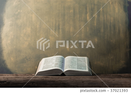 Bible and the crucifix on a old wooden oak table. Bible and the crucifix on a old wooden oak table. 37021393