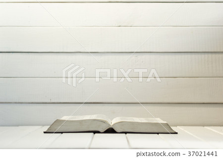Bible and the crucifix on a white wooden table. Bible and the crucifix on a white wooden table. 37021441
