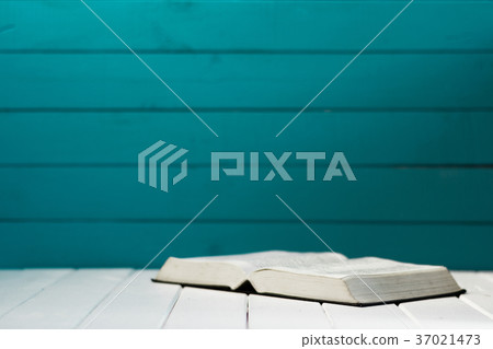 Bible on a white wooden table. Beautiful aquamarin Bible on a white wooden table. Beautiful aquamarin 37021473
