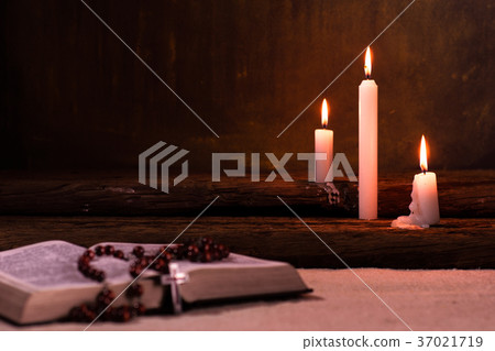 Bible crucifix and beads with a candle Bible crucifix and beads with a candle 37021719