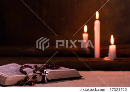 Bible crucifix and beads with a candle 37021720