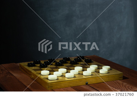 Chess board with chess on a red wooden table. Chess board with chess on a red wooden table. 37021760