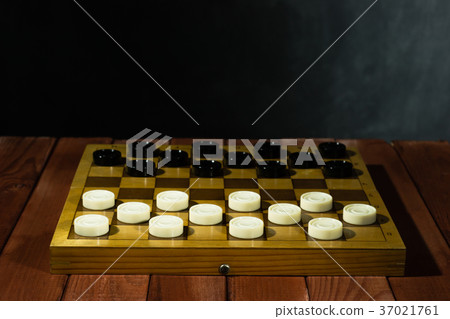 Chess board with chess on a red wooden table. Chess board with chess on a red wooden table. 37021761