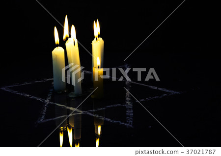 Five burning candles and the Star of David against 37021787