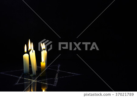 Five burning candles and the Star of David against 37021789