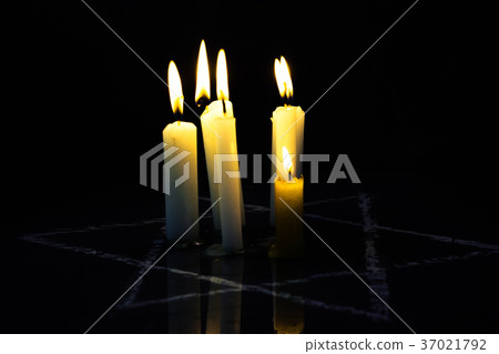 Five burning candles and the Star of David against Five burning candles and the Star of David against 37021792