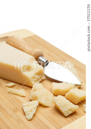 pieces of Parmesan cheese on wooden cutting board 37022256