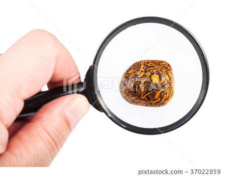 view of scriptstone gemstone through magnifier view of scriptstone gemstone through magnifier 37022859