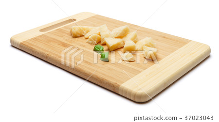 pieces of Parmesan cheese on wooden cutting board 37023043