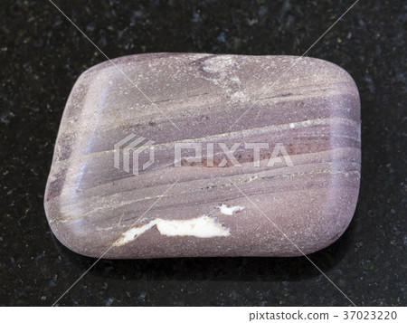 polished Argillite gemstone on dark background polished Argillite gemstone on dark background 37023220