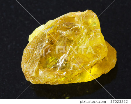 rough crystal of sulphur stone on dark background 37023222