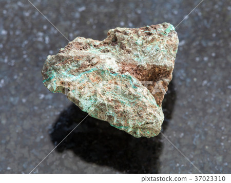 raw Malachite (copper ore) stone on dark raw Malachite (copper ore) stone on dark 37023310