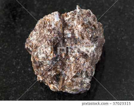 rough Phlogopite stone on dark background 37023315