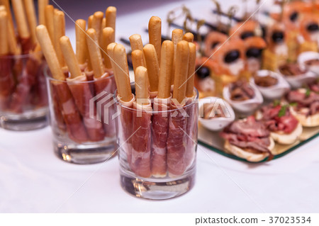bread sticks with a prosciutto in a glass bread sticks with a prosciutto in a glass 37023534
