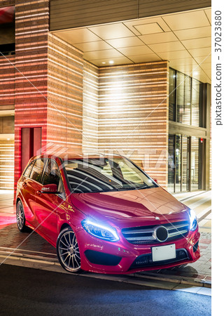 Night view with red car and apartment Night view with red car and apartment 37023880